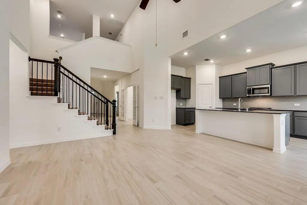 3900 Falcon Field Mesquite, TX 75181 - Photo 7 of 12 a view of kitchen with stainless steel appliances kitchen island wooden floor and living room view