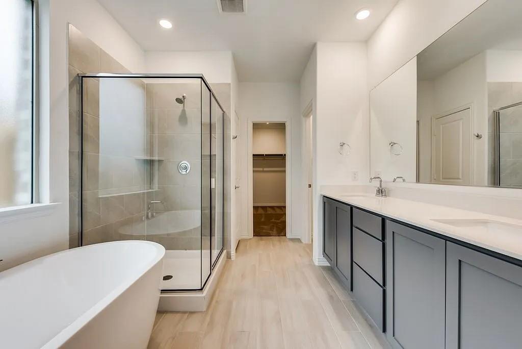 3900 Falcon Field Mesquite, TX 75181 - Photo 10 of 12 a bathroom with a tub sink shower and two mirror
