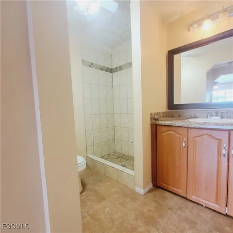 a view of a bathroom with a granite countertop sink