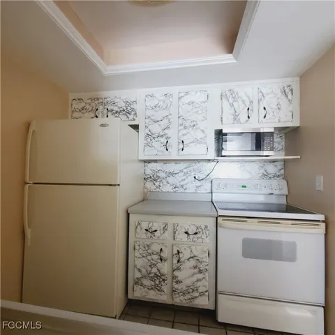 a utility room with cabinets washer and dryer