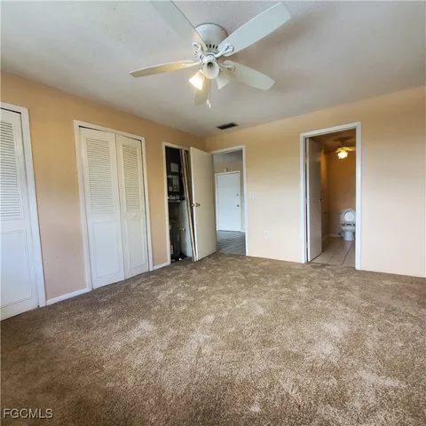 a view of an empty room with a ceiling fan