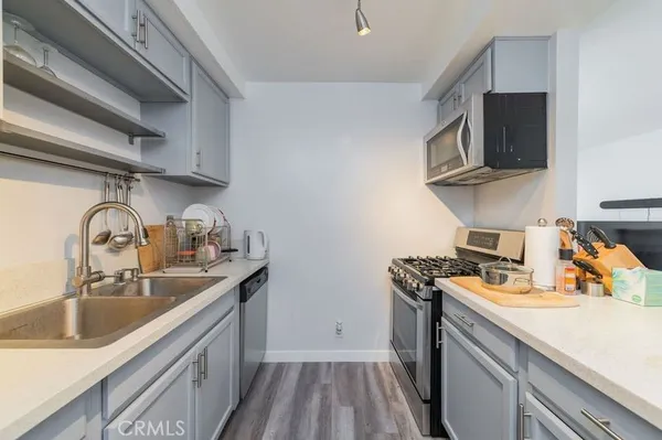 a kitchen with a sink a stove and cabinets