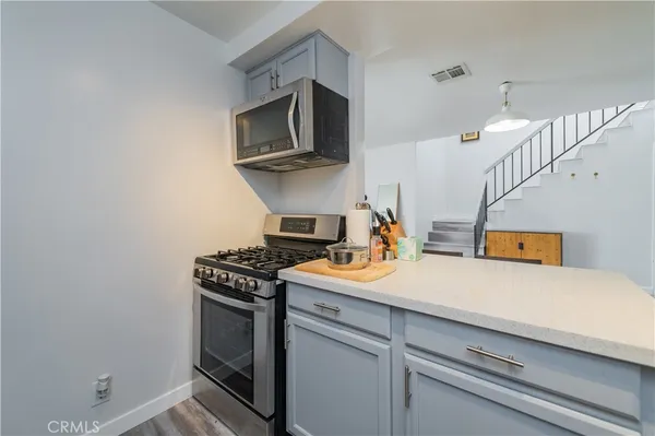 a kitchen with stainless steel appliances a sink stove and refrigerator