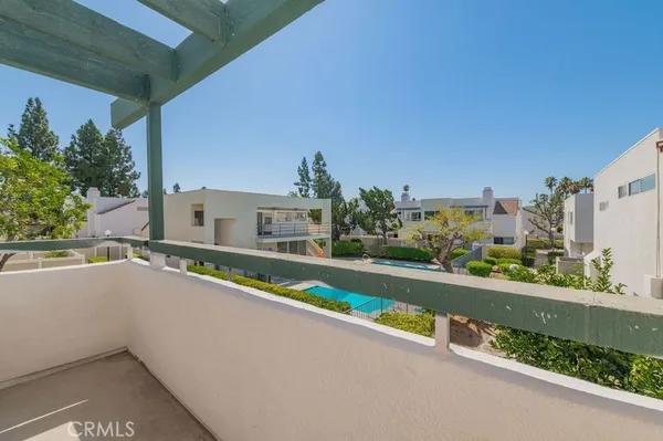 a view of a house with swimming pool and sitting area