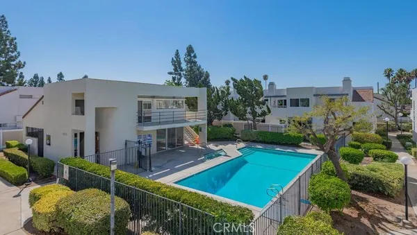 a view of a house with swimming pool and a yard