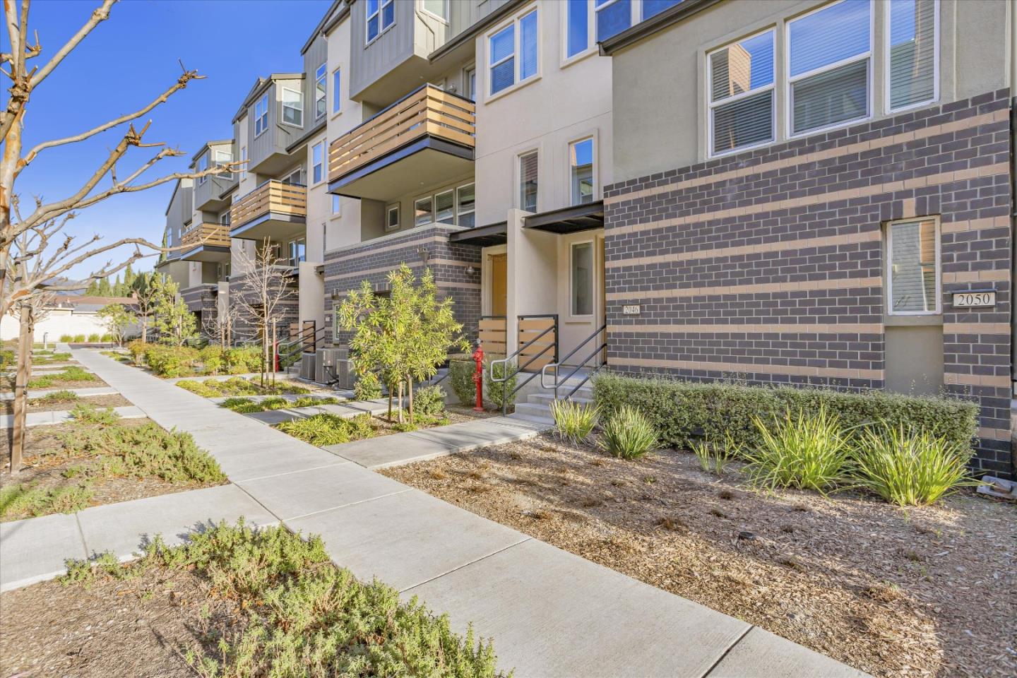 2046 Mahuron Circle San Jose, CA 95133 - Photo 2 of 35 a view of a brick building with many windows