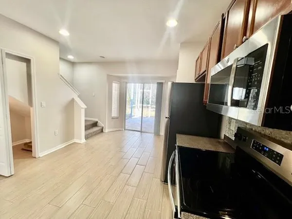 a view of hallway with stairs and wooden floor