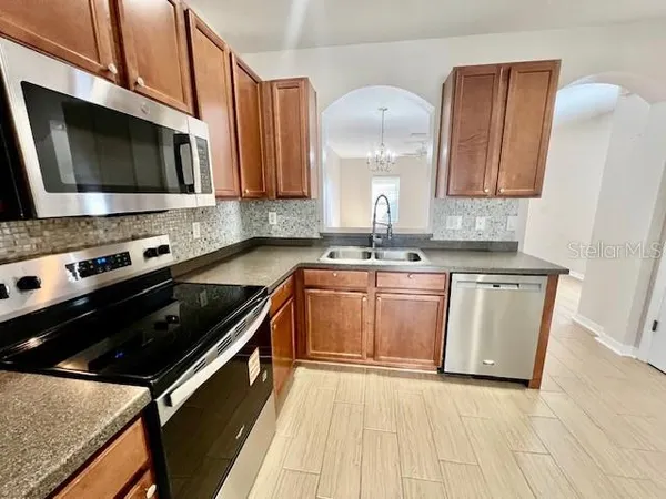 a kitchen with a sink stove and microwave