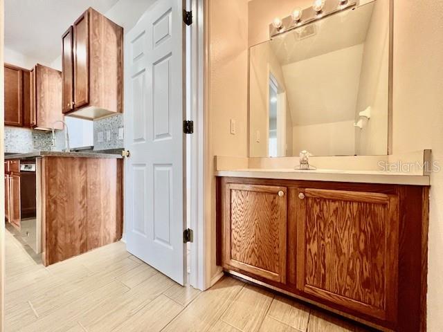 15633 Stable Run Drive Spring Hill, FL 34610 - Photo 20 of 50 a bathroom with a granite countertop sink and a mirror
