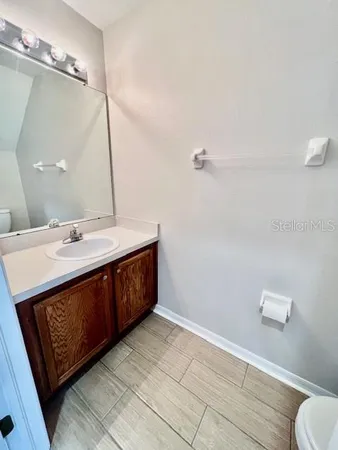 a bathroom with a sink a vanity and a mirror