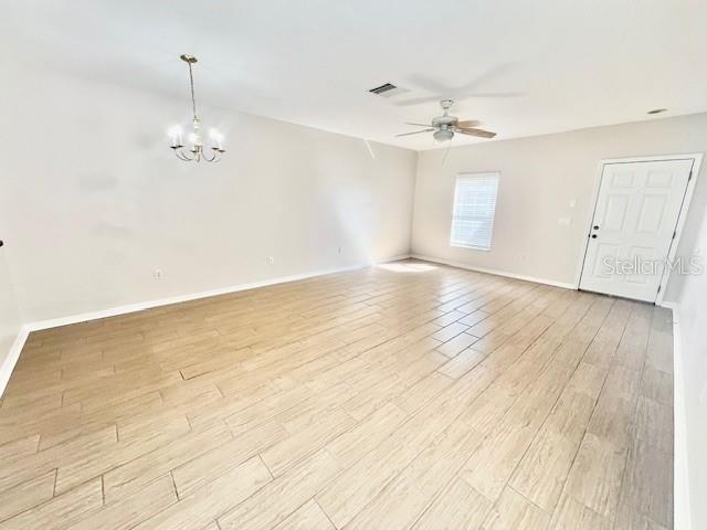 15633 Stable Run Drive Spring Hill, FL 34610 - Photo 4 of 50 an empty room with wooden floor ceiling fan and window