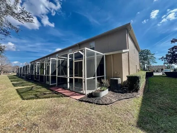a view of roof deck with couches and potted plants