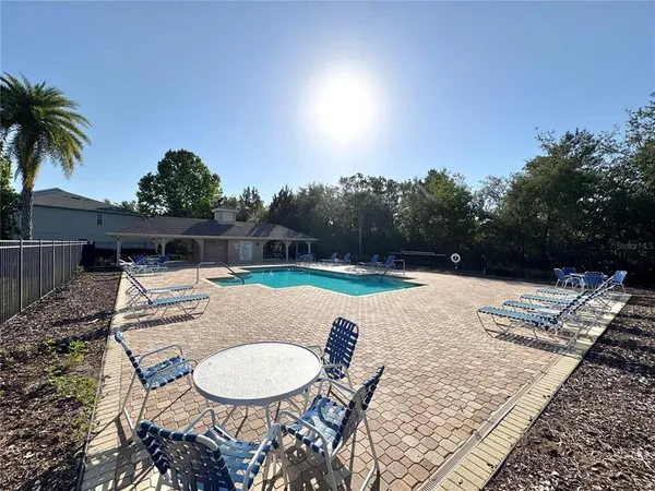 a backyard of a house with table and chairs