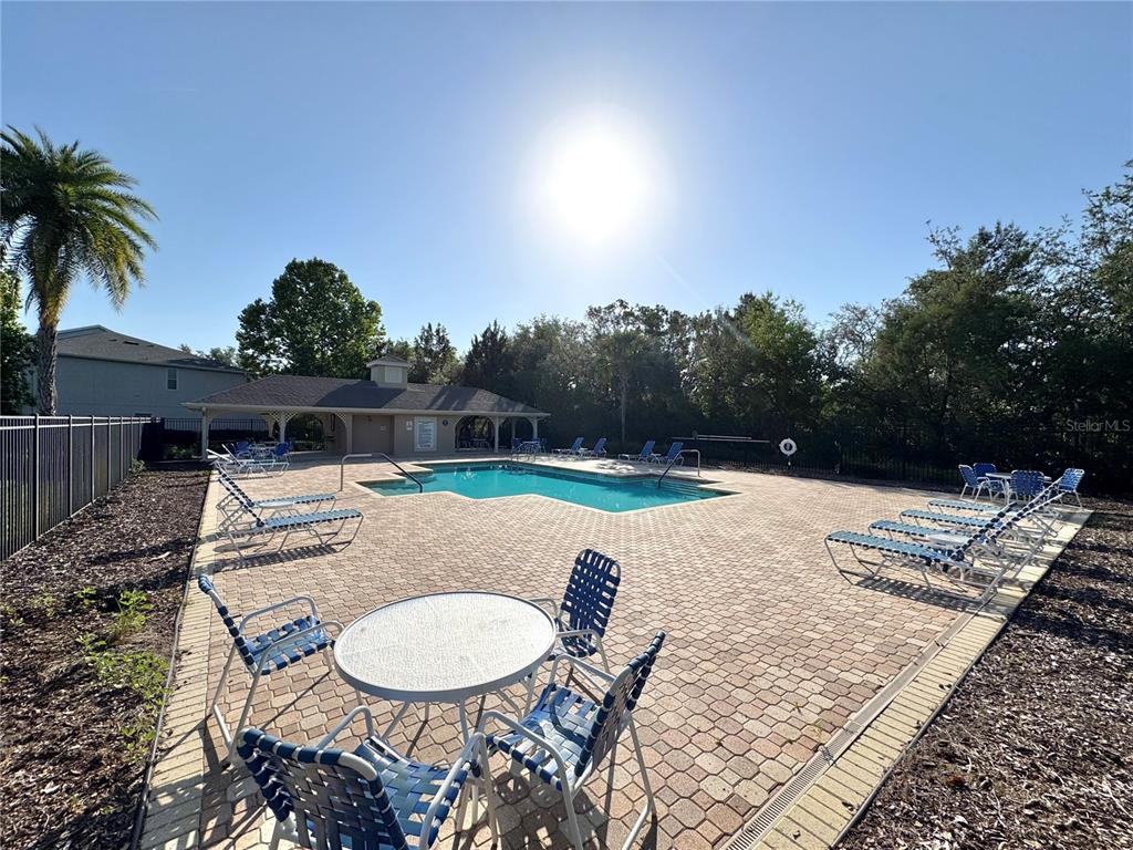 15633 Stable Run Drive Spring Hill, FL 34610 - Photo 50 of 50 a backyard of a house with table and chairs