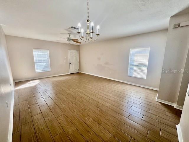 15633 Stable Run Drive Spring Hill, FL 34610 - Photo 6 of 50 an empty room with wooden floor and windows
