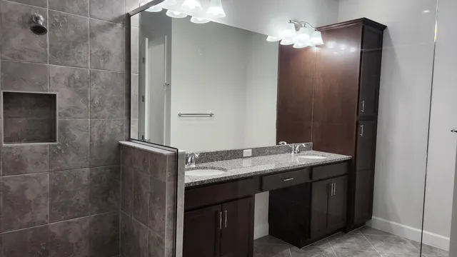 a bathroom with a shower and a sink