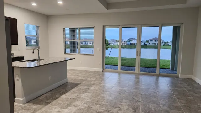 a view of a kitchen with granite countertop a sink and a counter top space