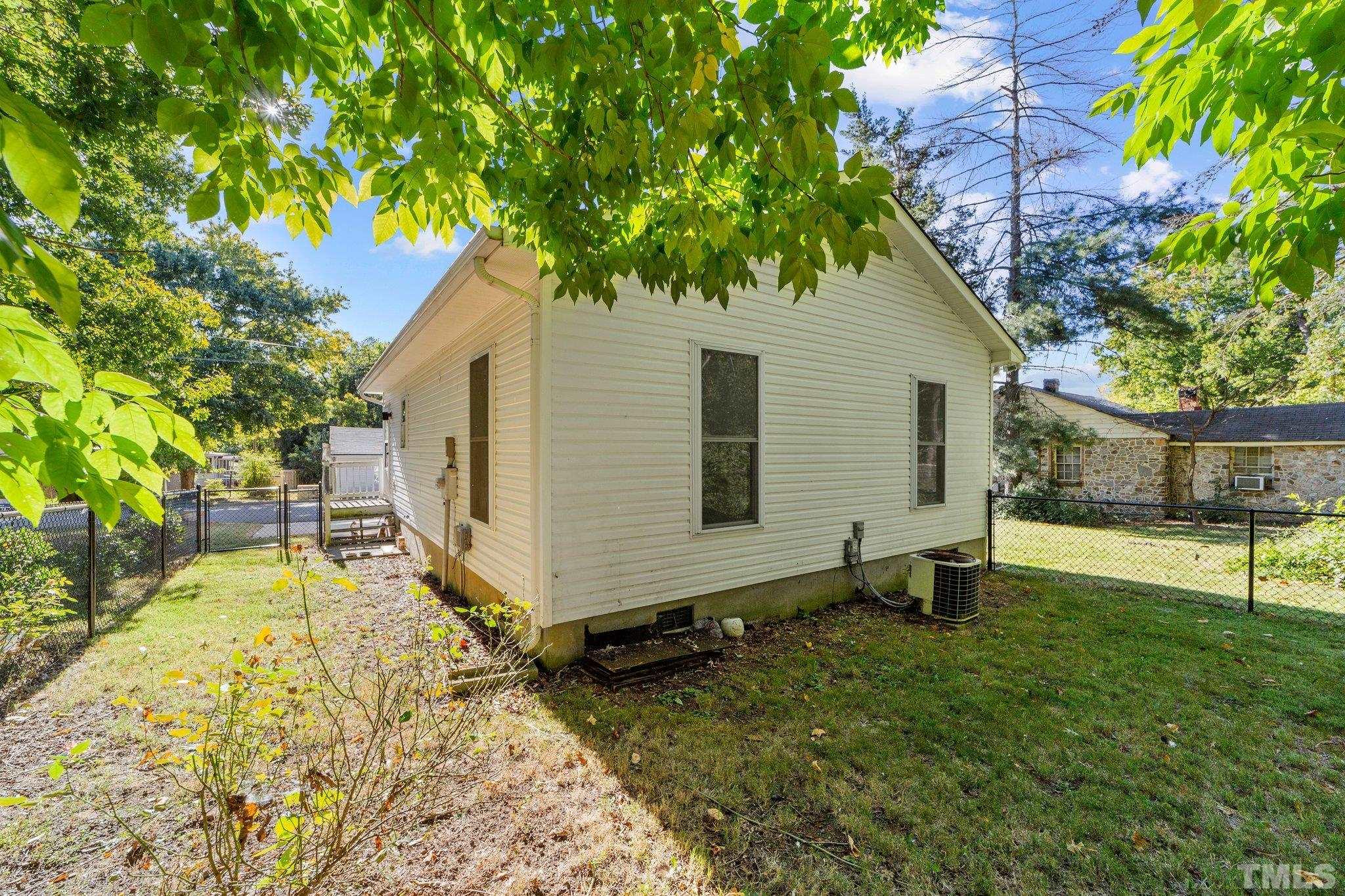 513 Jones Street Roxboro, NC 27573 - Photo 8 of 29 a backyard of a house with table and chairs