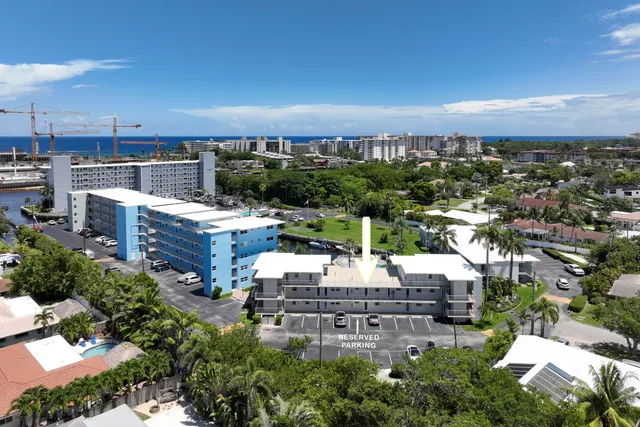 a kitchen with stainless steel appliances granite countertop a stove top oven a sink and a refrigerator