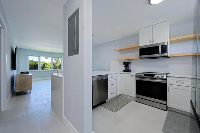 a large kitchen with a counter space a sink and appliances