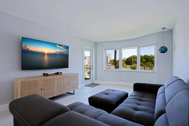 a spacious bedroom with a bed and a flat screen tv