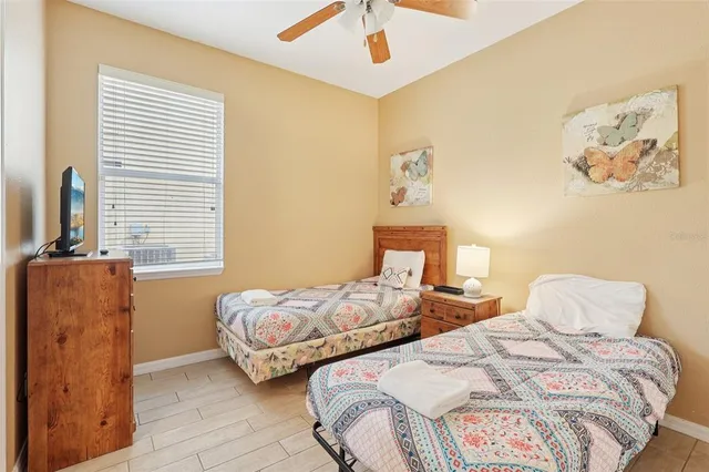 a bedroom with two beds and painting on the wall