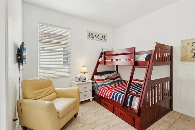 a bedroom with furniture and a large window