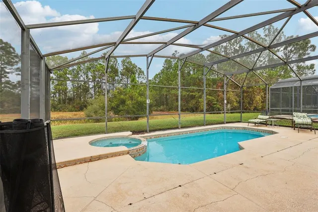 a view of a backyard with a swimming pool