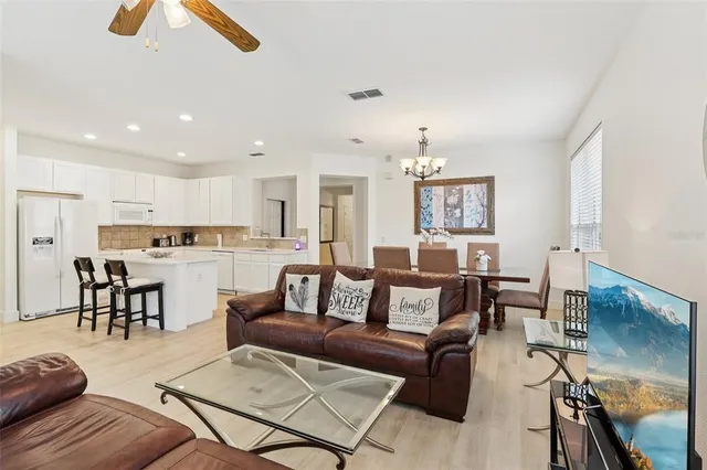 a living room with furniture and kitchen view
