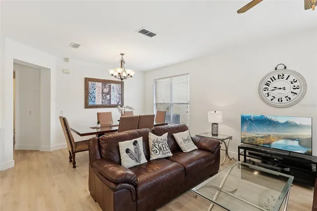a living room with furniture a rug and a wall painting
