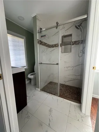a bathroom with a glass shower door