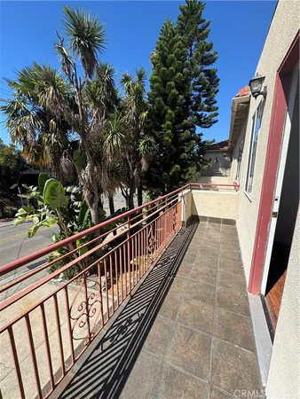 a view of balcony with wooden floor and fence