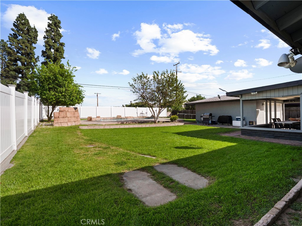 1455 North Alice Avenue Rialto, CA 92376 - Photo 8 of 23 a view of a house with a big yard and a large tree