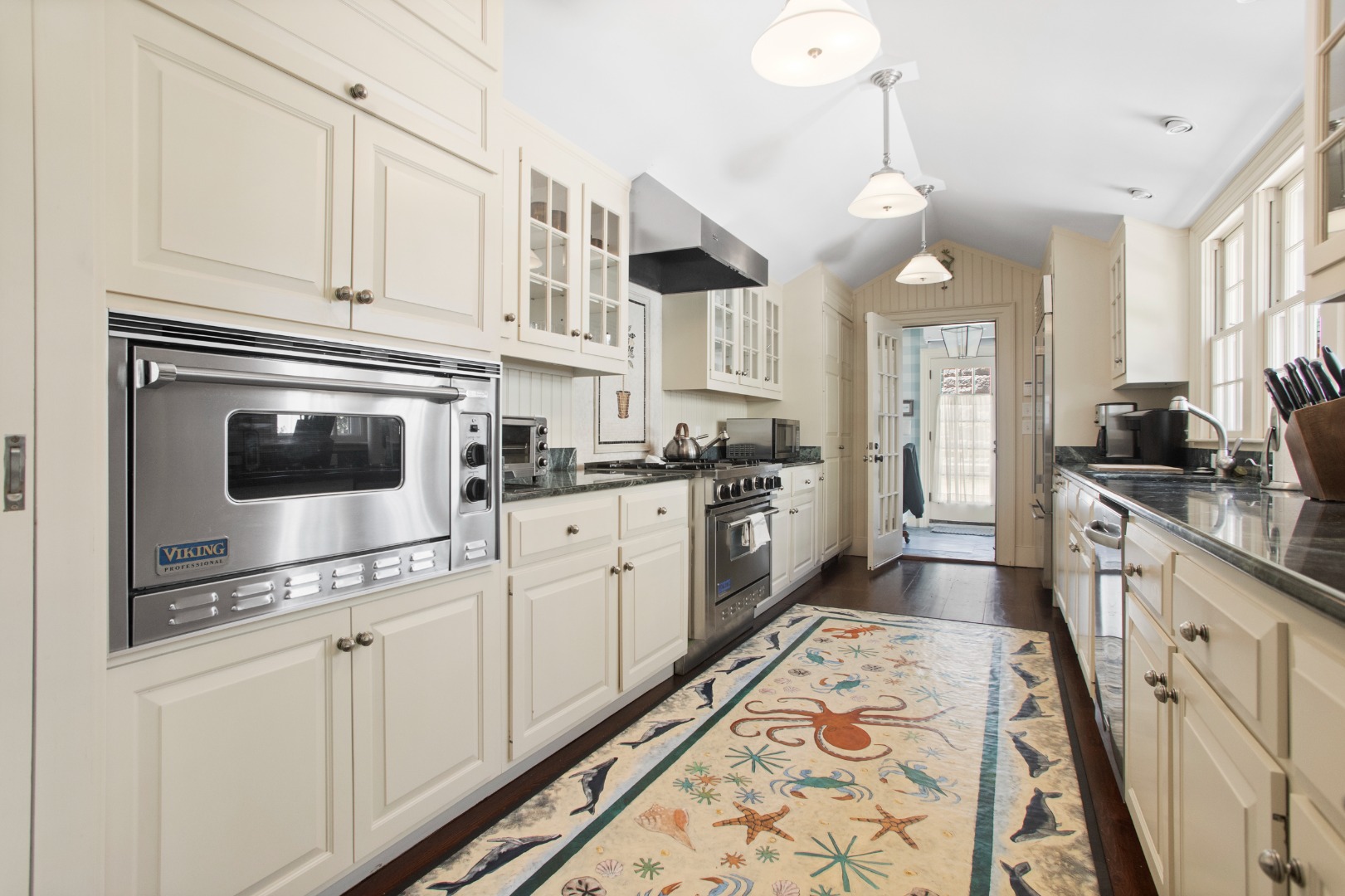 19 Orange Street Nantucket, MA 02554 - Photo 21 of 85 a kitchen with granite countertop a sink and cabinets
