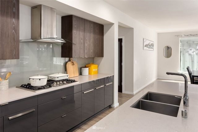 a kitchen with stainless steel appliances granite countertop a stove and a sink