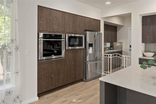 a kitchen with stainless steel appliances a refrigerator and a stove top oven