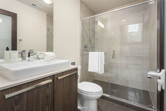a bathroom with a sink toilet and shower