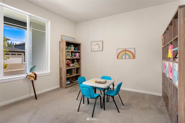 a view of a livingroom with furniture and a book shelf