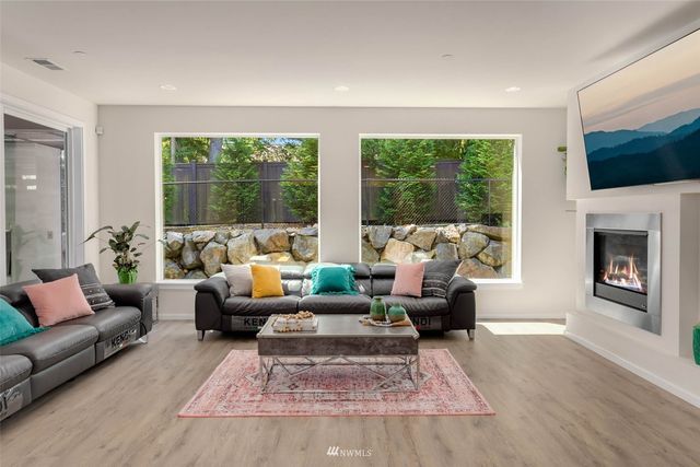 a living room with furniture large window and a fireplace