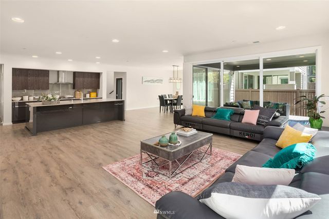 a living room with furniture and view of kitchen