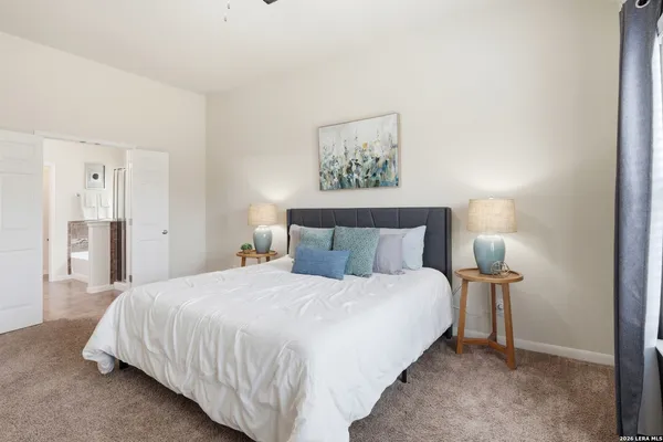 a bedroom with a bed and a lamp