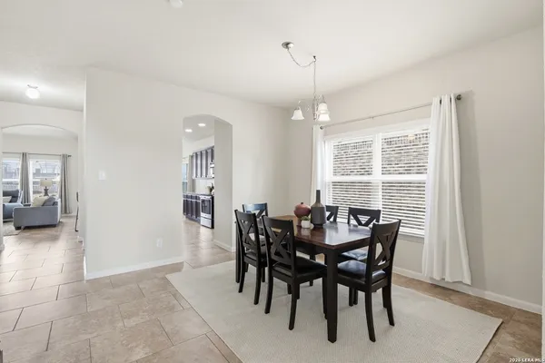 a view of a dining room with furniture and window