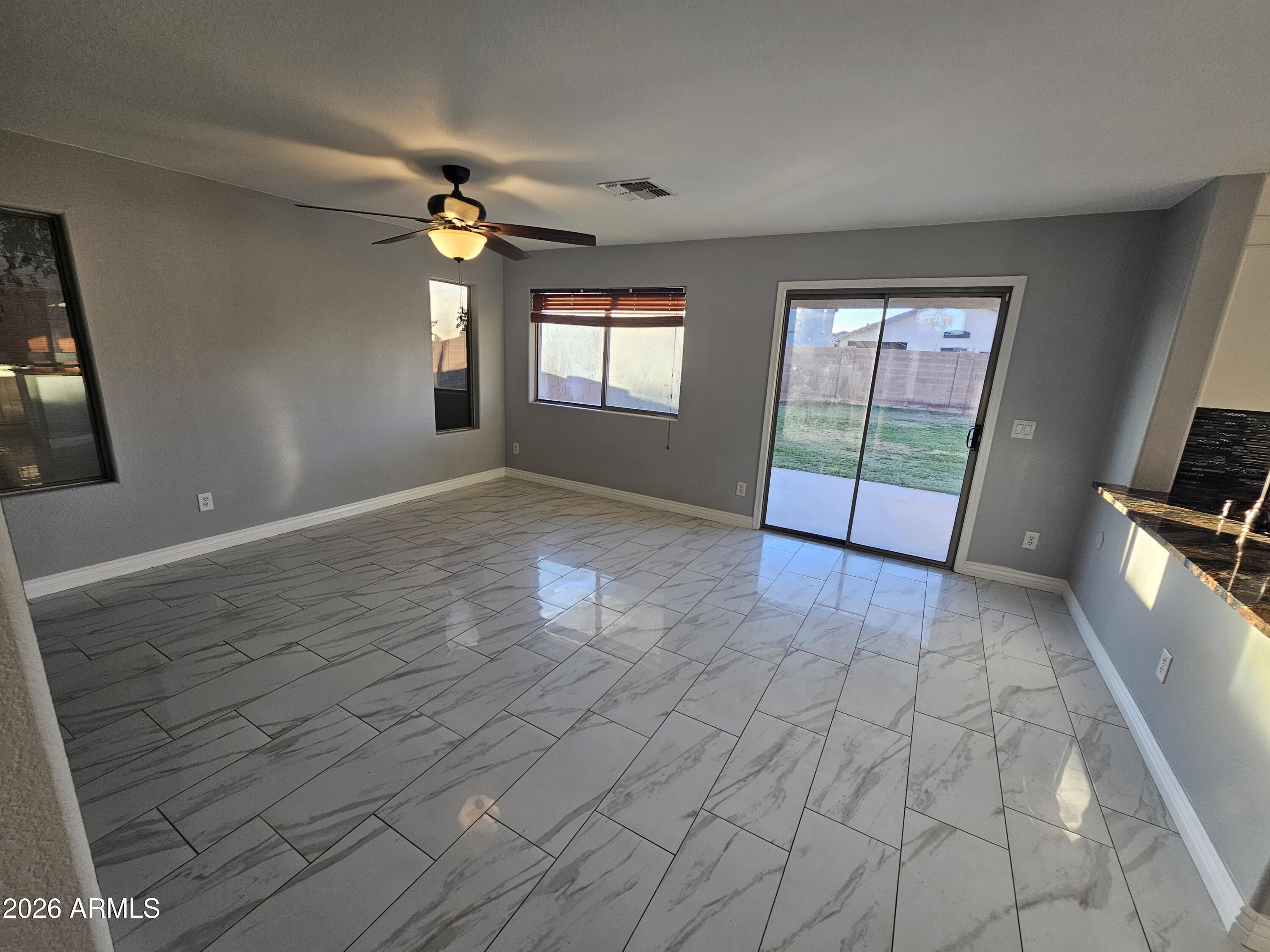 941 Mountain View Road San Tan Valley, AZ 85143 - Photo 11 of 48 wooden floor in an empty room with a window