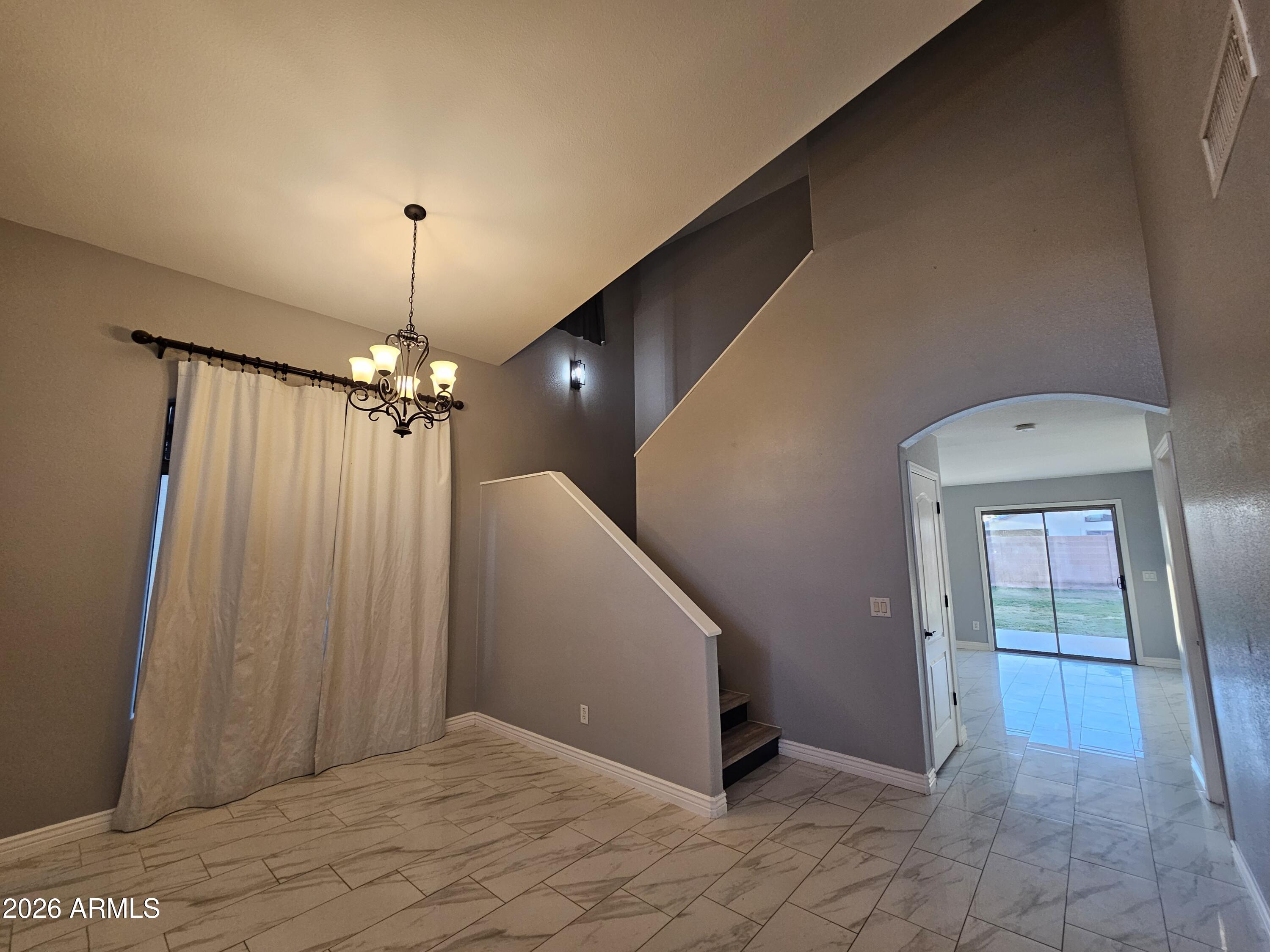 941 Mountain View Road San Tan Valley, AZ 85143 - Photo 13 of 48 a view of a hallway with a chandelier fan and a livingroom