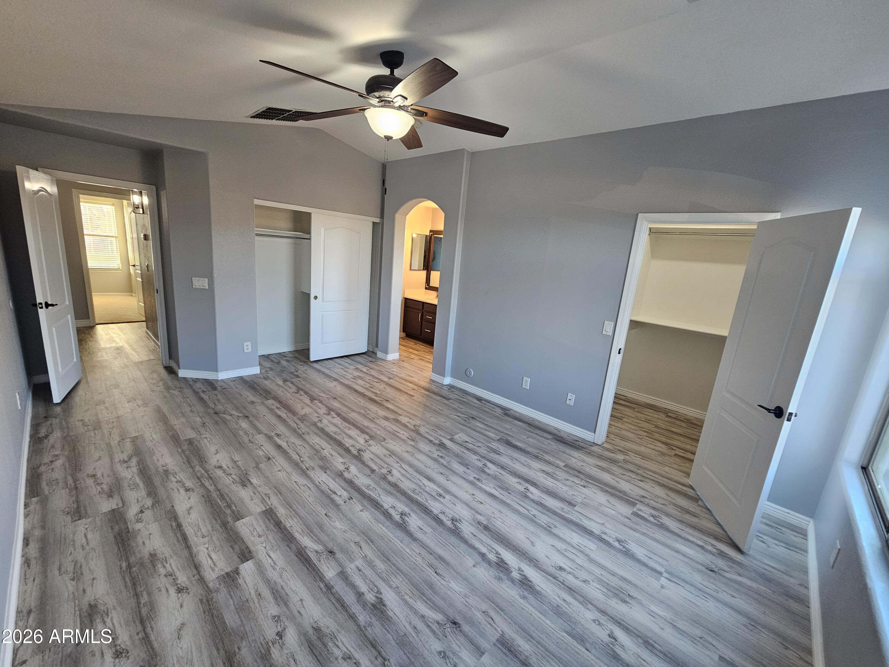 941 Mountain View Road San Tan Valley, AZ 85143 - Photo 20 of 48 a view of an empty room with wooden floor and a window