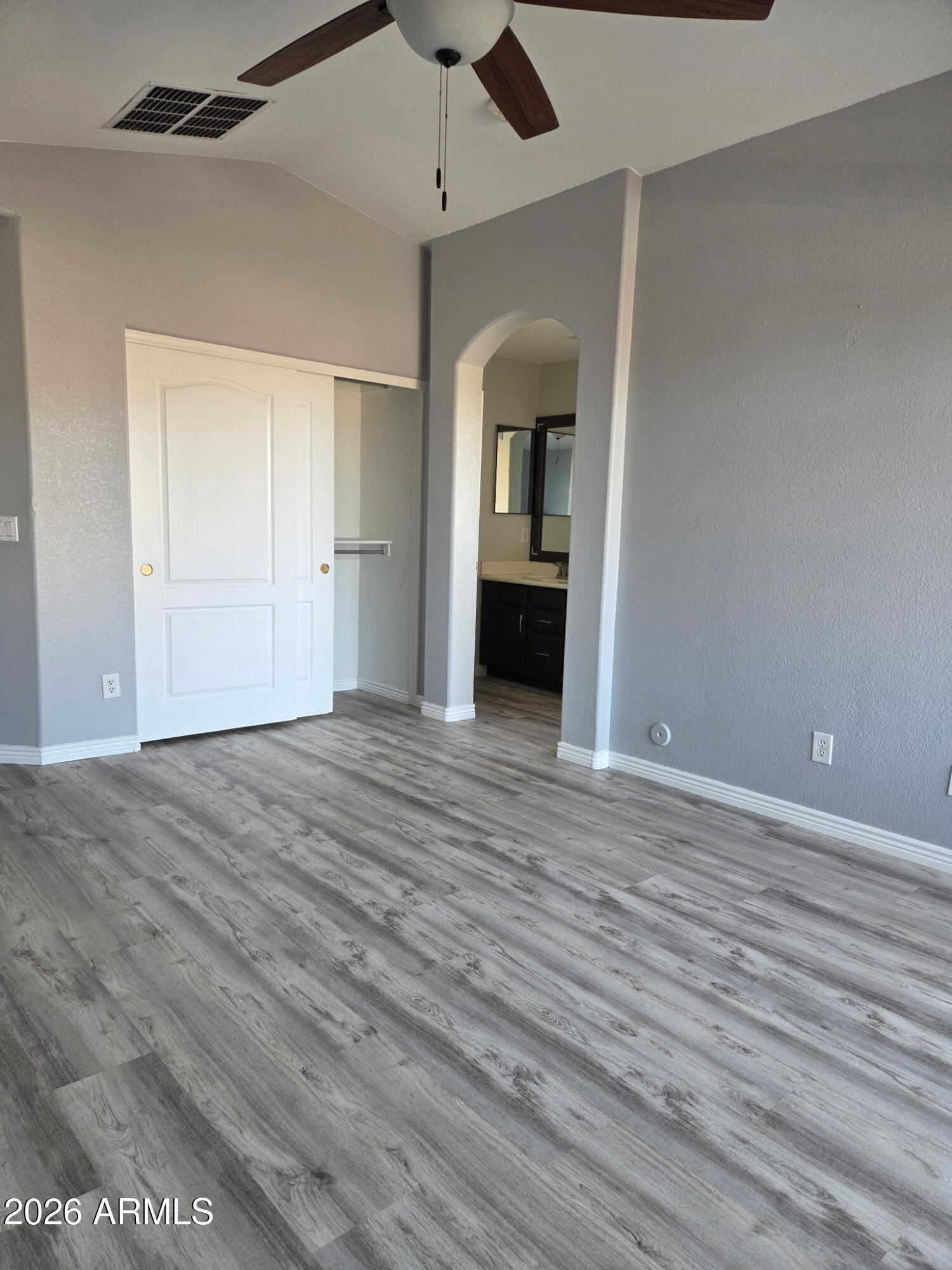941 Mountain View Road San Tan Valley, AZ 85143 - Photo 21 of 48 a view of a room with wooden floor and a ceiling fan