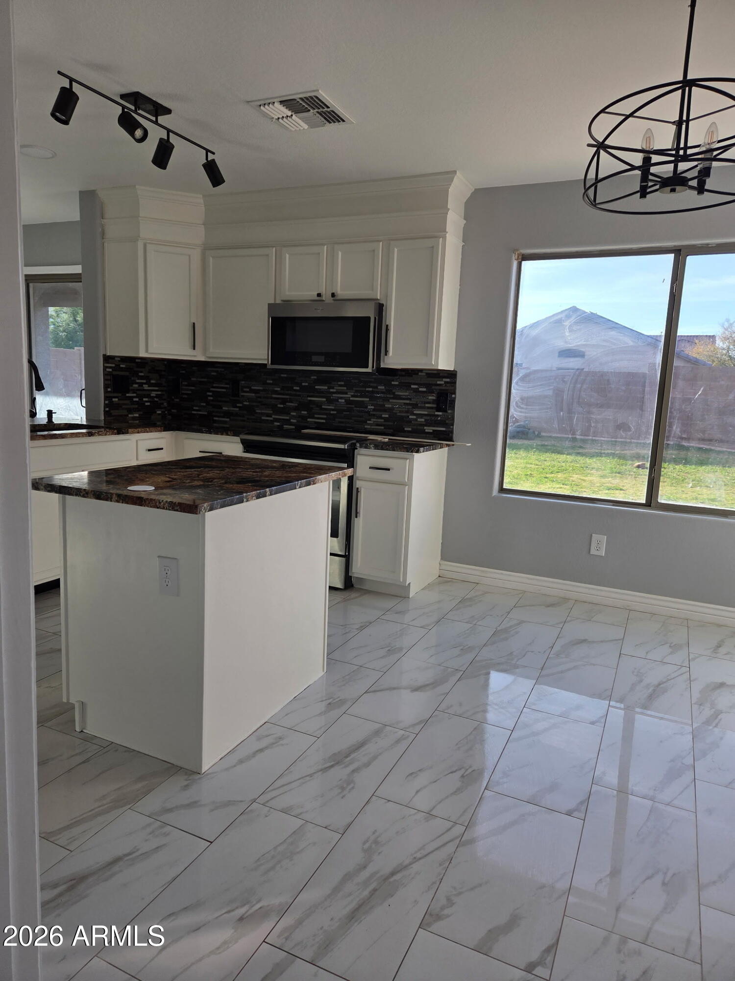 941 Mountain View Road San Tan Valley, AZ 85143 - Photo 7 of 48 a kitchen with stainless steel appliances a stove a sink and a microwave