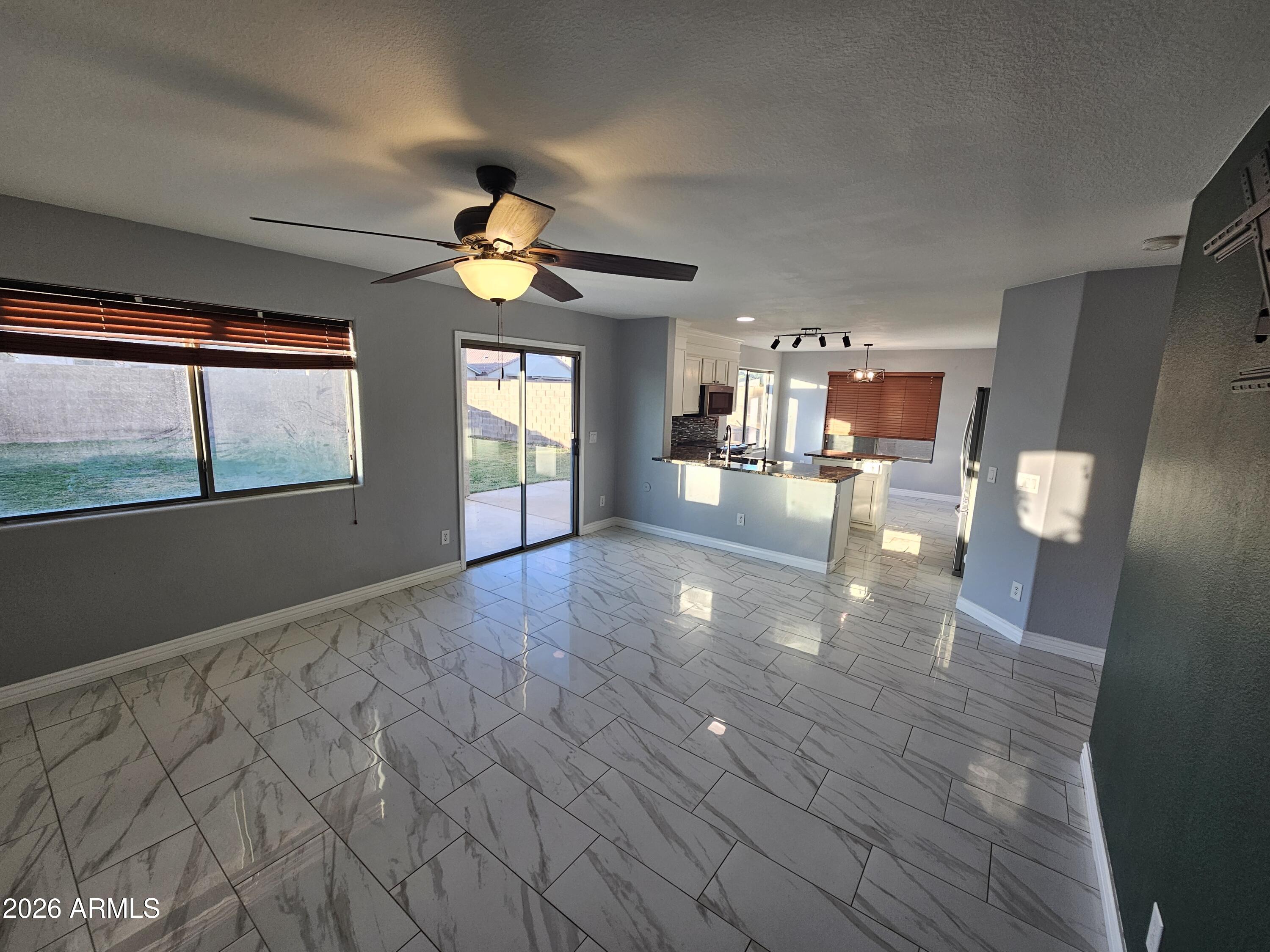 941 Mountain View Road San Tan Valley, AZ 85143 - Photo 9 of 48 a view of empty room with wooden floor and fan
