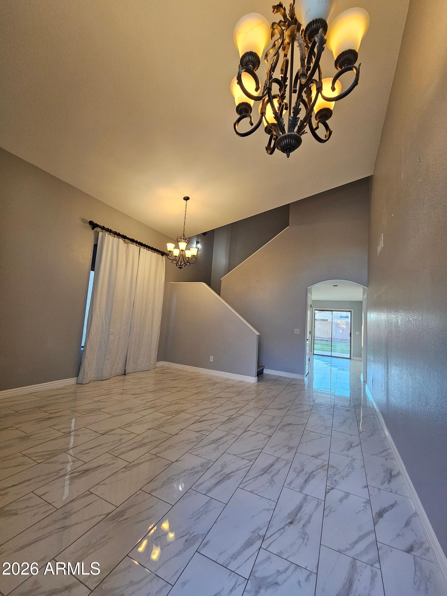 941 Mountain View Road San Tan Valley, AZ 85143 - Photo 10 of 48 a view of an empty room with window and chandelier fan