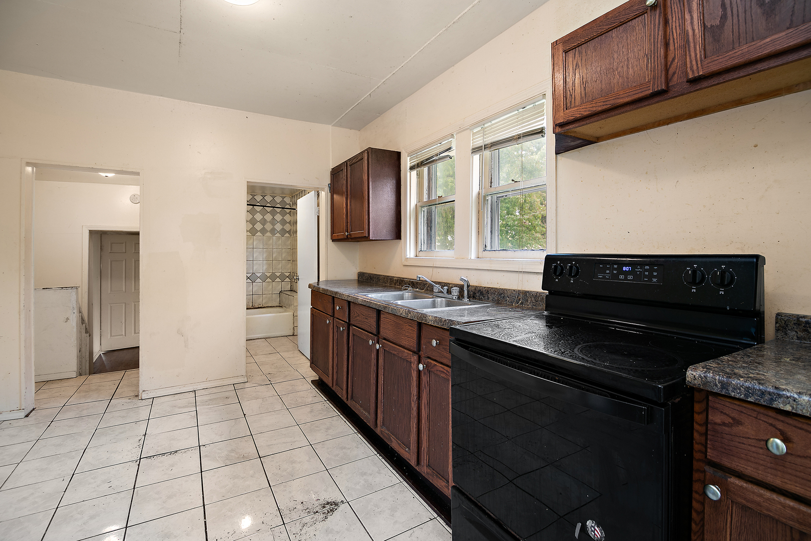 1990 Patrick Avenue Kankakee, IL 60901 - Photo 11 of 15 a kitchen with stainless steel appliances granite countertop a stove a sink and a microwave